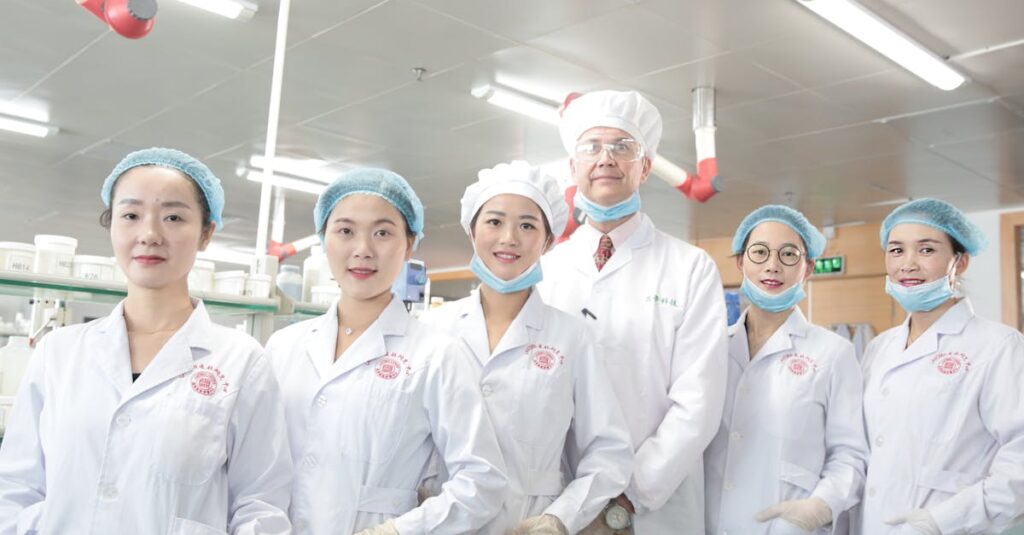 Team of healthcare workers in a laboratory wearing uniforms and safety gear.